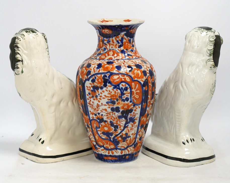 A pair of Victorian comforter spaniels and an Imari vase, vase 31cm high. Condition - fair, vase with a crack to the base